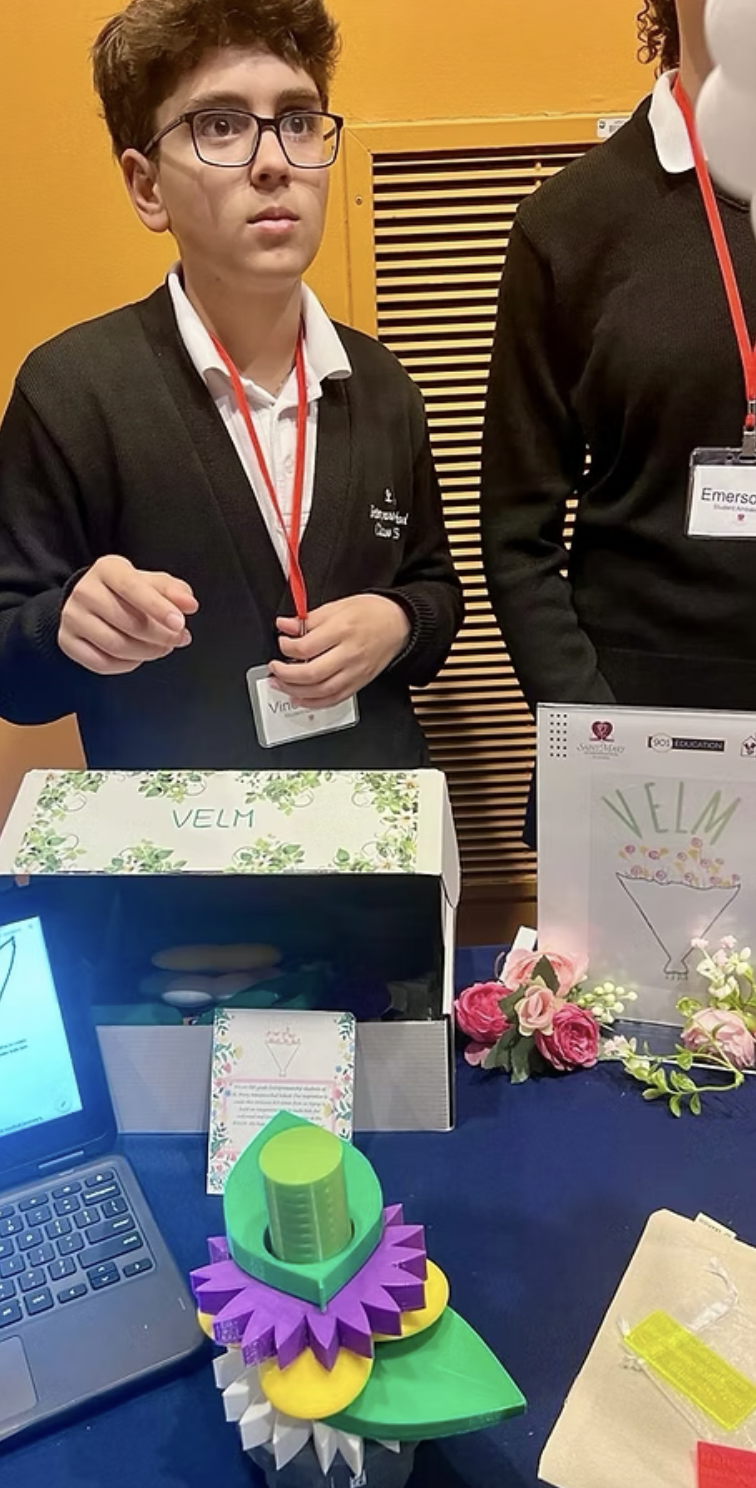 Student shows final project at at entrepreneurship presentation.